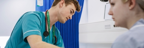 A student in scrubs in our Centre for Simulation in Health and Care